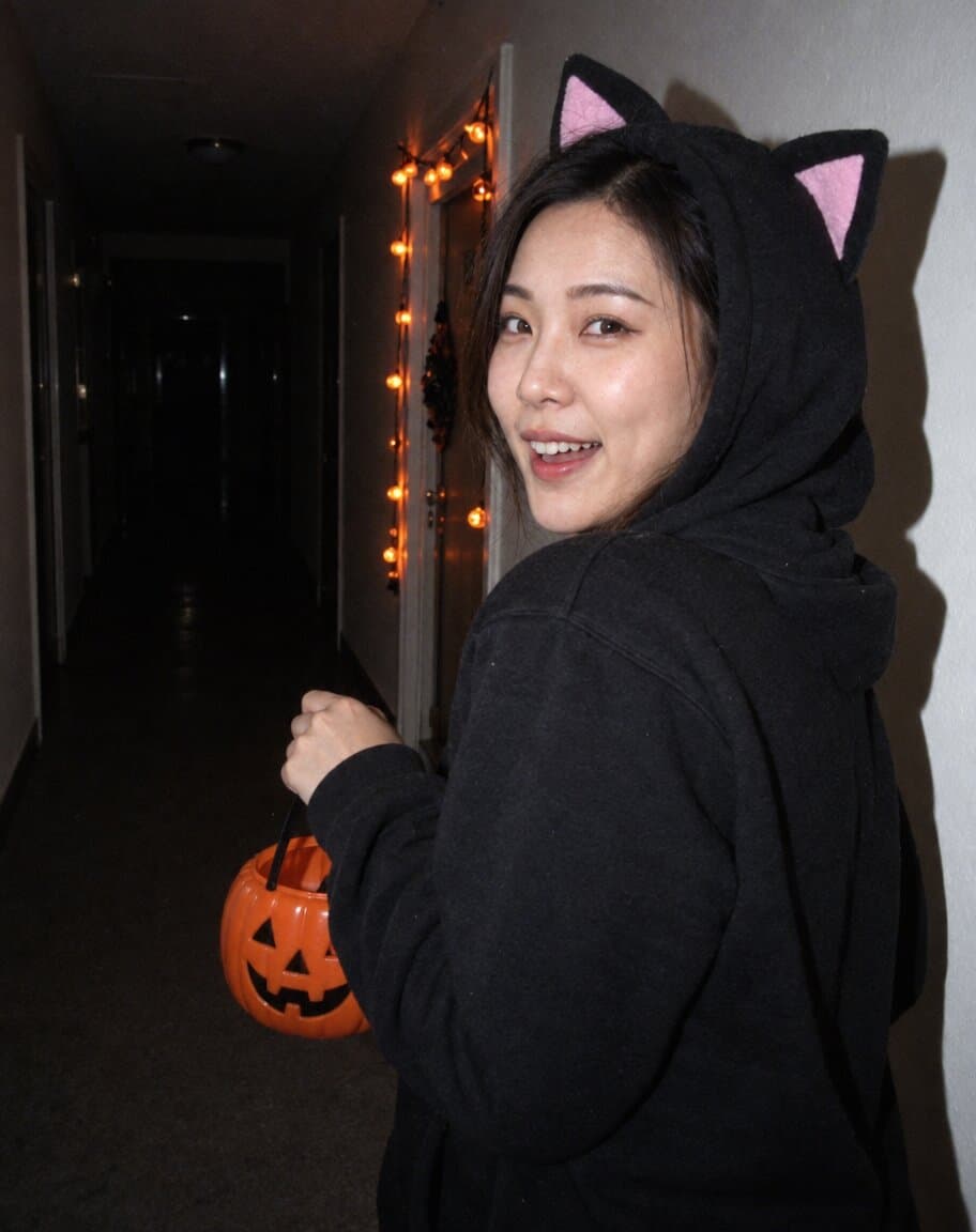 Early-2000s flash photo of a startled woman in a dark hallway